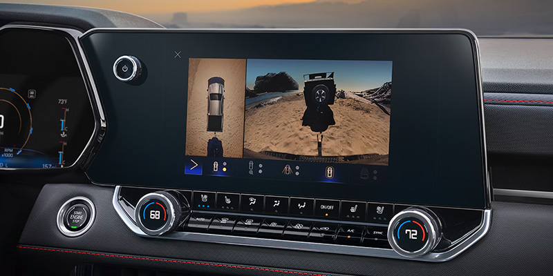 2025 Chevrolet Colorado dashboard display showing a 3D view of a vehicle on a beach and control buttons.