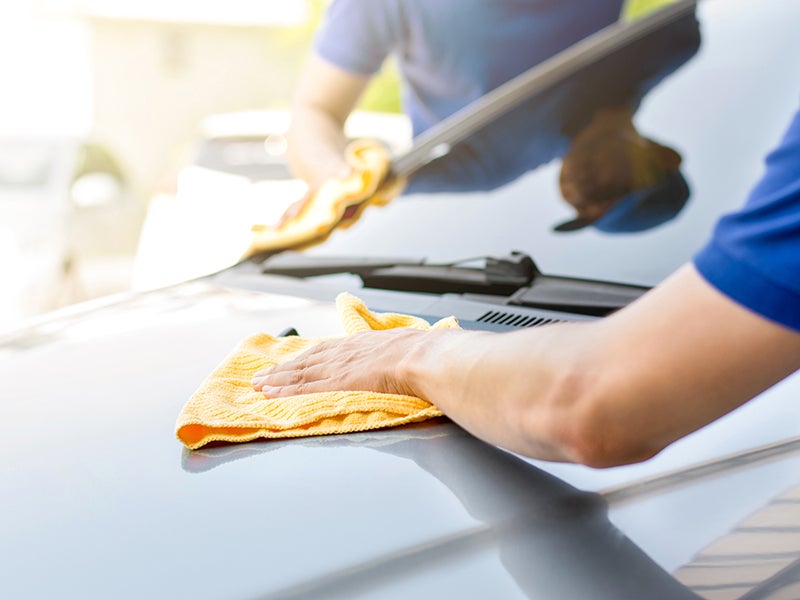 A men is cleaning a car