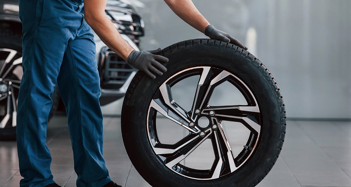 A mechanic holding Tire