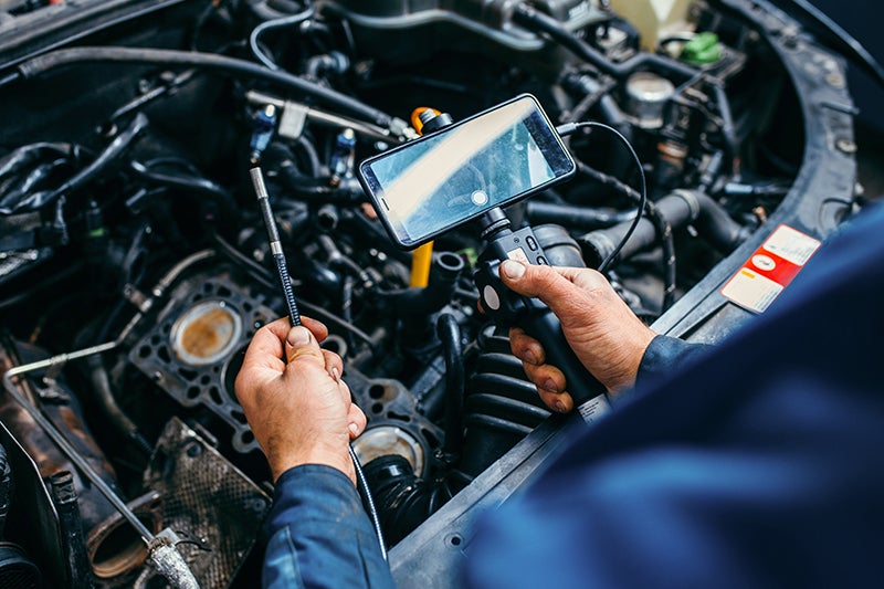 service technician pointing at vehicle